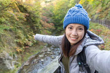 Woman taking selfie at forest landscape