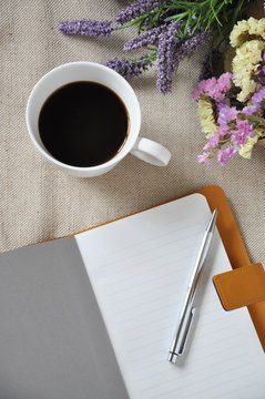 Top View of Coffee Cup with Blank Notebook