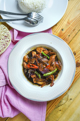 Chicken in black soya sauce and rice. wooden background