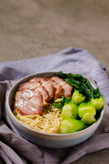 Egg noodle served dry with red roast pork, Chinese food