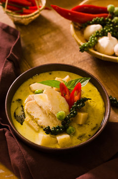 Chicken mussaman curry in bowl vegetables on wooden background