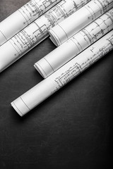 Construction planning drawings on black background