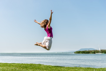 Girl jumping on the lake