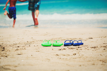 father and son go swim at beach