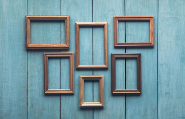Fototapeta na wymiar old frames on wooden wall