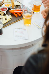 Person writing on drink rating list