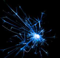 blue sparks of fire on a black background
