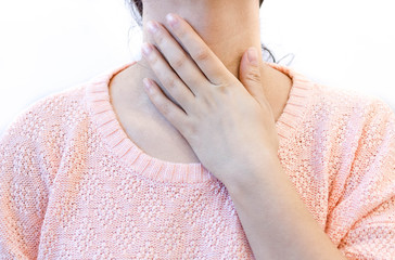 woman with throat pain, thyroid gland control. Young female touches her neck, white background.