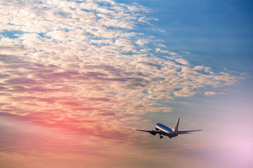 Fototapeta na wymiar Airplane taking off at the sunset sky
