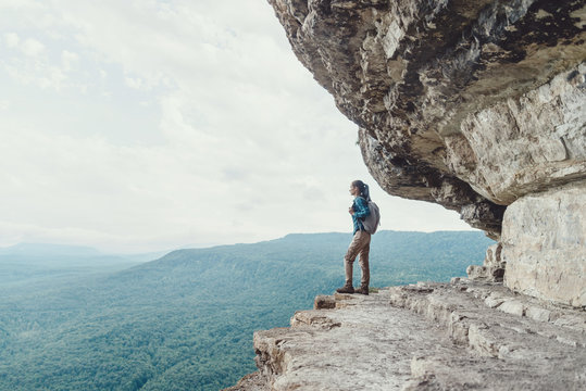 Traveler standing on cliff