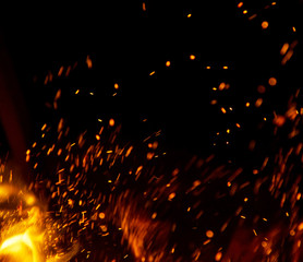 Fototapeta na wymiar fire flames with sparks on a black background