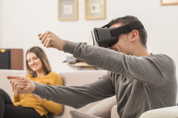 Fototapeta premium young man uses a virtual reality glasses , VR mask