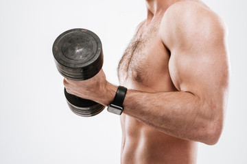 Fototapeta na wymiar Cropped photo of handsome athlete standing with dumbbell
