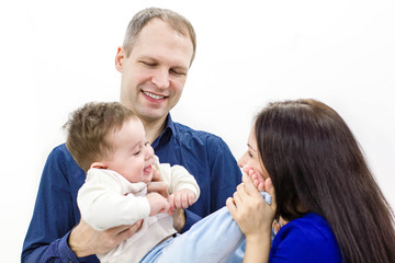Smiling young parents and their child are very happy, they are at home. happy family mother, father and son on white background