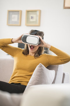 young woman uses a virtual reality glasses, VR mask