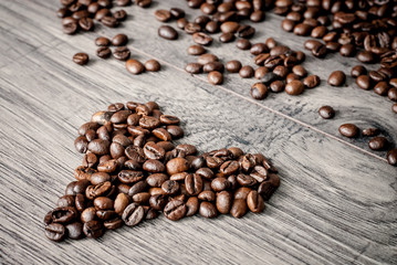 Coffee beans concept on wooden table background.