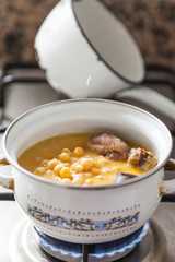 Chickpea stew  in a saucepan, spanish cocido