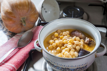 Chickpea stew  in a saucepan, spanish cocido