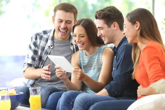 Happy Friends Watching Media In A Tablet