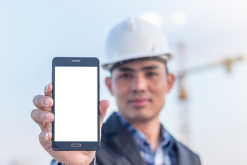 Architects holding a smartphone  isolated white screen with crane background