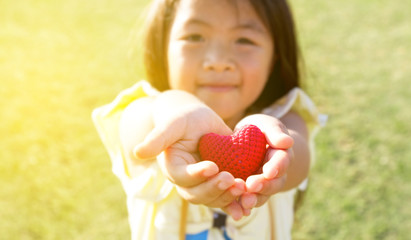 child holding heart in hands