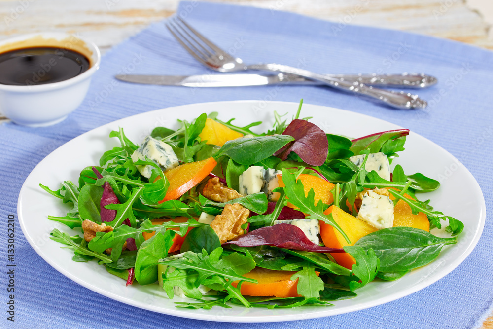 Wall mural persimmon salad with lettuce leaves, blue cheese and walnuts