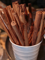 Closeup of Brown Cinnamon Sticks inside White Container