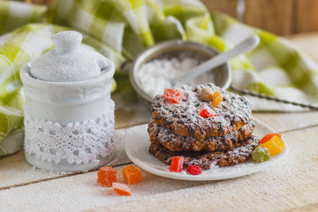 Cookies on the plate with sugar powder and candied peels