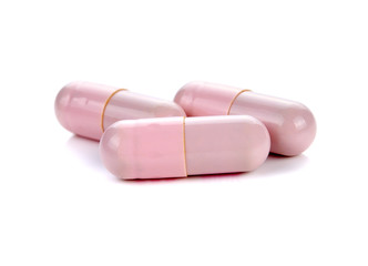 pink pill capsules on white background