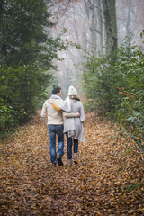 Fototapeta premium Young couple Walking Winter Woodland