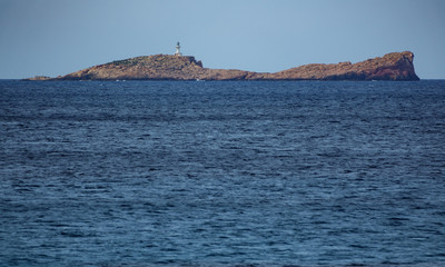 Fototapeta na wymiar Lighthouse on top of rock island