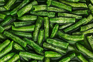Wet fresh green french bean in water  closeup as background. Healthy vitamin food.