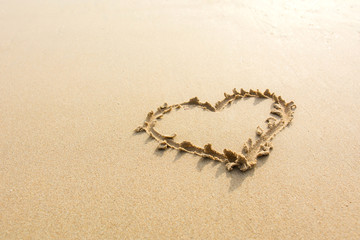 Draw heart on beach. valentine day