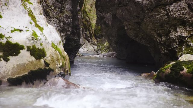 River in Slovenia running under rocks mountain creek, tranquil environment 4K
