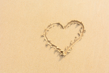 Draw heart on beach. valentine day