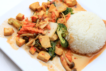 Stir Fried Tofu with Gravy Sauce and mixed vegetables in white plate on white background. Vegetarian Food, healthy food.