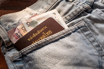Thailand Passport with cash in denim jeans pocket