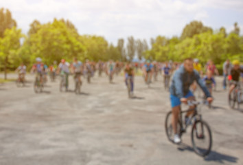 A group of cyclists organized a summer arrival on bikes on the road. The concept of a healthy lifestyle and sports.