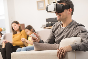 young man uses a virtual reality glasses , VR mask