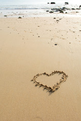 Draw heart on beach. valentine day