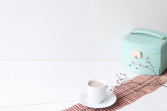 Minimal elegant composition with turquoise box and coffee cup