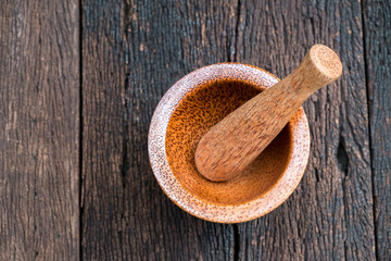asia antique style wooden mortar with wooden pestle on old wood table.