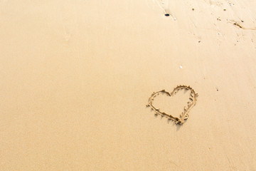 Draw heart on beach. valentine day