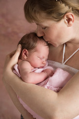 Newborn baby girl in her mother's hands