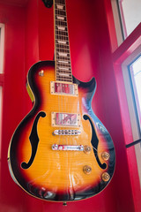 Naklejka na ściany i meble Beautiful sunburst electric guitar in the shop
