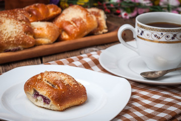 Buns with berries on a wooden table.