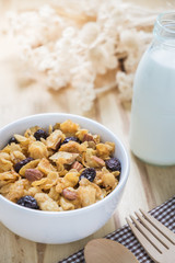Corn flakes nutrition cereal and milk on wooden surface for healthy breakfast