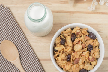 Corn flakes nutrition cereal and milk on wooden surface for healthy breakfast, Top view