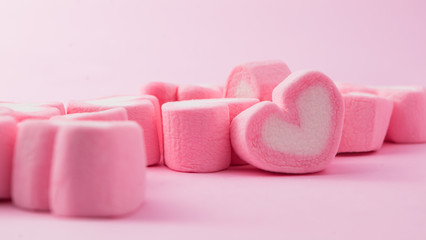 Pink heart-shaped marshmallow in with pink background