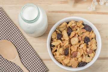 Corn flakes nutrition cereal and milk on wooden surface for healthy breakfast, Top view